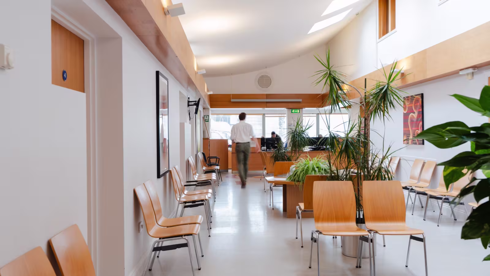 A member of the team walking through the waiting area towards reception