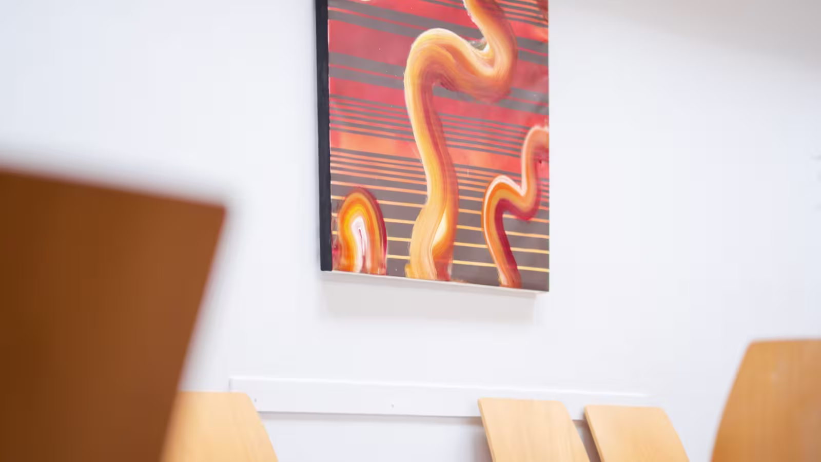 Seating beneath a painting in the waiting area